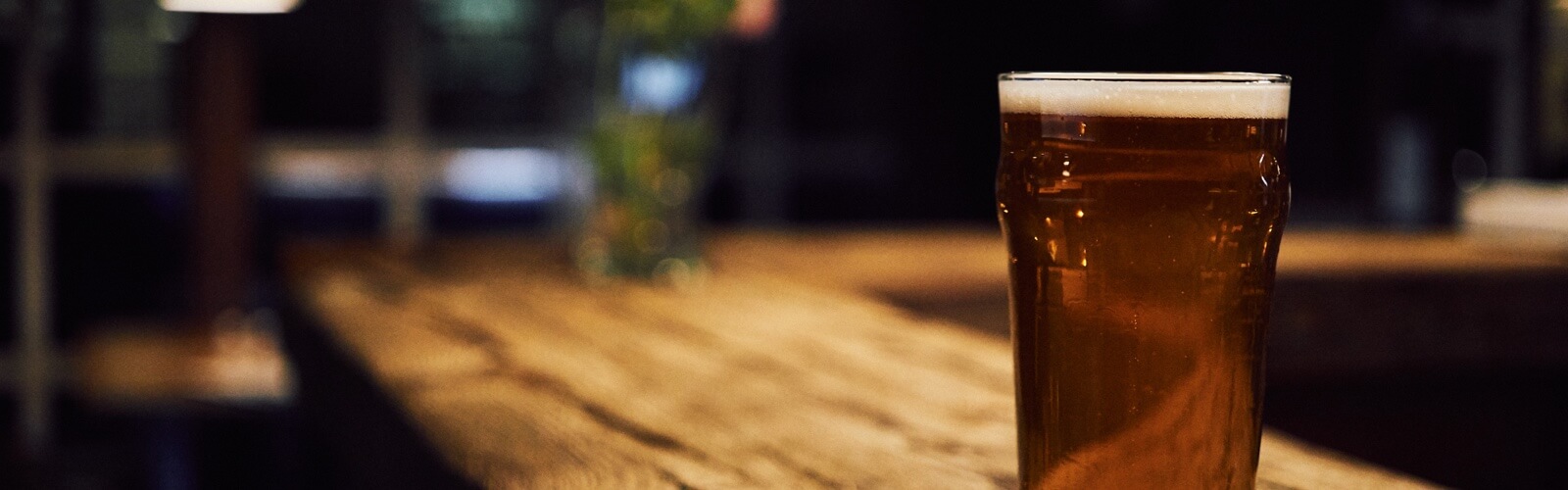 focused full glass of beer on the counter at the bar 